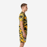 Left side view of mens custom yellow soccer uniform showing full camo print coverage on jersey and shorts