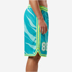 Front view of custom sublimated mens basketball shorts in teal and neon lime with elastic striped waistband and V-notch hem split