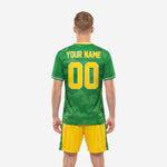 Kelly Green camo custom soccer jersey close-up showing sublimated crew neck collar with white trim and gold chest lettering