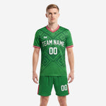Mens custom Kelly Green soccer uniform with geometric sublimation pattern, red trim collar and cuffs, and matching green shorts - front view