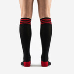 Close-up of triple red stripe ribbed cuff band on custom black soccer socks for mens teams
