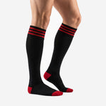 Mens custom red and black soccer socks with red heel and toe contrast panels shown from the side