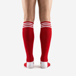 Custom red soccer socks cuff detail showing three white hooped stripes on ribbed elastic band