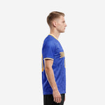 Side view of men custom soccer jersey in Royal Blue showing Athletic Gold sleeve cuff trim and tonal scroll sublimation