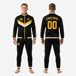 Men's custom soccer tracksuit in black and gold with ribbed ankle bands and matching stripe trim, full set view