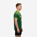 Mens custom training jersey in Forest Green and Neon Green showing dot-burst graphic across right shoulder and sleeve, left side view