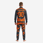 Close detail of the geometric full-dye sublimation print on the orange and charcoal soccer tracksuit jacket chest
