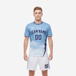 Mens gradient custom light blue soccer uniform with navy lightning bolt and white shorts - front view