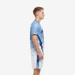 Custom light blue soccer uniform with navy side panel bolt graphic - left side view