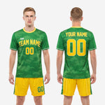 Mens green and gold custom soccer uniform full kit back view showing player surname and back number on camo jersey