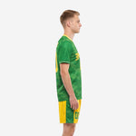 Mens green soccer uniforms left side view showing camo sublimation print and Athletic Gold contrast shorts with green side stripe