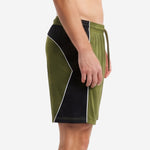 Athletic fit mens green soccer shorts side panel construction in Army Green and Black with white piping seam