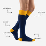 Close-up of mens navy blue soccer socks showing ribbed cuff texture and colorfast polyester knit