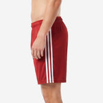 Mens red soccer shorts side panel detail with sublimated white stripes on crimson polyester fabric
