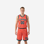 Adult male wearing the coral-orange side of reversible basketball uniform with teal trim, arched team name and number 00 on chest