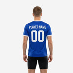 Close side angle of a royal blue practice jersey highlighting the white contrast trim at the V-neck collar and sleeve cuff