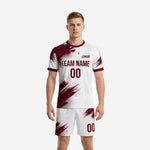 Men's soccer team uniforms in custom maroon and white splash-pattern full-dye sublimation, front view showing team name and number zones on jersey and matching shorts
