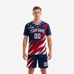 Men's soccer team uniforms in navy blue and crimson diagonal splash print with white stars, full kit front view