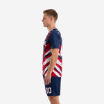 Adult soccer uniform set in navy blue with red and white sublimated splash pattern, right side profile view