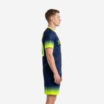 Custom men's soccer team uniforms showing Navy Blue to Neon Yellow gradient fade on jersey and shorts, left side view