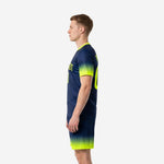 Sublimated men's soccer team uniforms in Navy Blue and Neon Yellow gradient, right side view showing sleeve cuff and shorts hem fade