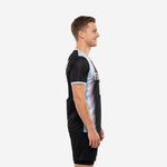 Custom mens soccer training top in black with iridescent side panel, silver-grey V-neck collar and sleeve cuffs, left side view