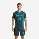Mens teal soccer uniforms front view showing charcoal jersey with teal spike-burst print and matching shorts