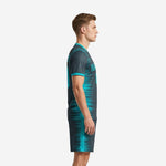 Custom teal and charcoal soccer uniform left side view showing full-dye sublimation spike pattern on jersey and shorts