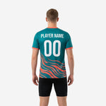 Close detail of coral wave sublimation print on teal soccer training jersey lower body