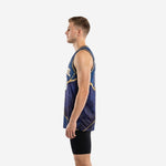 Side view of navy and gold sublimated basketball jersey showing side vents at hem, gold armhole binding, and marble-crack pattern across the body