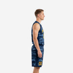 Front view of custom navy and gold basketball uniforms showing V-neck jersey with digital camo print, gold arced team name, and matching camo shorts