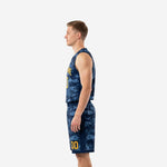 Side view of navy and gold digital camo basketball uniform set showing V-neck jersey armhole binding and shorts side profile