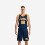 Custom navy and gold reversible basketball uniforms with chevron side panels, arced team name, and matching shorts shown front view