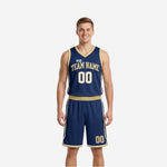 Navy and gold reversible basketball uniforms front view showing navy jersey with gold trim, arched team name, and matching navy shorts with gold side stripe