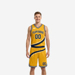 Gold side of custom navy and gold reversible basketball uniforms with navy diagonal stripe, arched team name, front number, and V-neck binding on adult male model