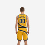 Gold side view of reversible basketball uniform showing navy stripe continuation from jersey hem through matching shorts on adult male model