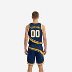 Side view of navy and gold reversible basketball uniform showing armhole binding and diagonal stripe panel break across jersey and shorts