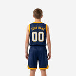Back view of navy and gold youth basketball uniform set showing back name and number print zones on navy jersey and matching navy shorts with gold trim on youth boy model
