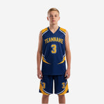 Front view of custom navy and gold youth basketball uniforms showing V-neck jersey with geometric gold panels and matching shorts with player number 3