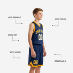 Side view of navy and gold youth basketball uniform set showing gold armhole binding, navy shorts with gold chevron accent at lower leg and player number in gold on youth boy model
