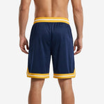 Close detail of gold chevron hem band and white accent stripe on custom sublimated navy basketball shorts