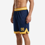 Opposite side view of navy and gold basketball shorts showing clean flat side seam and leg opening split detail