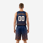 Left-side view of custom navy basketball uniform set with Aztec diamond pattern on shorts and orange hem band
