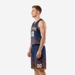 Side view of navy sublimated basketball jersey and shorts showing orange armhole binding and geometric lower panel