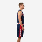 Side view of custom navy and red basketball uniform set showing red side panel on jersey and vertical team name on shorts leg