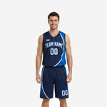 Navy blue basketball uniform full set showing arched team name on jersey chest and matching royal blue panel shorts on male model front view