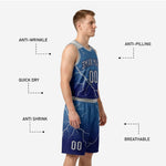 Detail view of the navy blue basketball shorts showing lightning-crack sublimation pattern, elastic waistband, drawcord, and player number on the lower leg