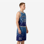 Side view of the navy blue basketball uniform showing gradient from sky blue shoulders to deep navy hem with full lightning-crack print on jersey and shorts
