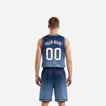 Opposite side view of navy blue pinstripe basketball uniform set showing gradient fade from deep navy to steel blue across jersey and shorts
