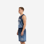 Side view of navy blue basketball uniform showing sleeveless jersey length, wide armhole binding, and matching gradient shorts with drawcord waistband